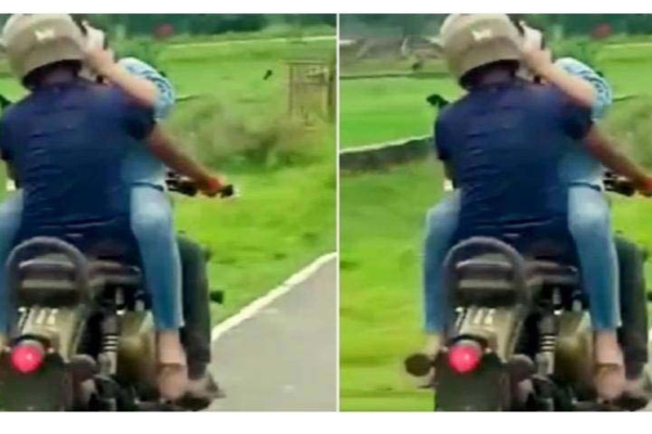 பைக்கில் செல்லும் போதே கட்டிப்பிடித்து முத்தம்: காதல் ஜோடியின் முகம் சுழிக்கும் புகைப்படம் | Couple On A Royal Enfield Engage Kiss