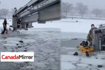 உறைந்துபோன ஆற்றுக்குள் சிக்கிக் கொண்ட தம்பதி; ராட்சத கிரேன் மூலம் மீட்பு