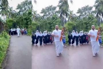 வெறிநாய் தொல்லை; துப்பாக்கி ஏந்தியவரின் பாதுகாப்போடு பள்ளி செல்லும் குழந்தைகள்