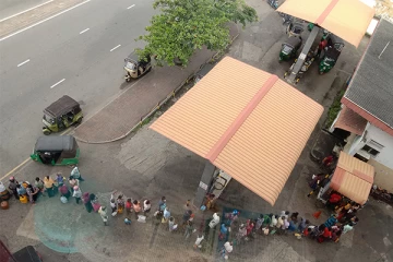 எரிபொருள் நிரப்பு நிலையங்களுக்கு முன் நீண்ட வரிசையில் காத்திருக்கும் மக்கள்