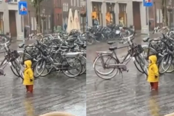 கொட்டும் மழையில் உல்லாசமாக படுத்த குழந்தை - பார்வையாளர்களை கவர்ந்த வீடியோ