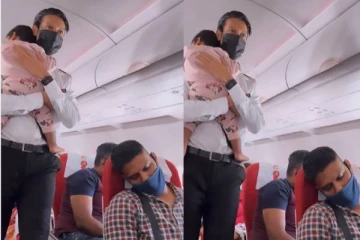 கதறிய குழந்தையை தோளில் சாய்த்து ஆறுதல் கூறிய விமான ஊழியர்! இதயங்களை வென்ற காட்சி!